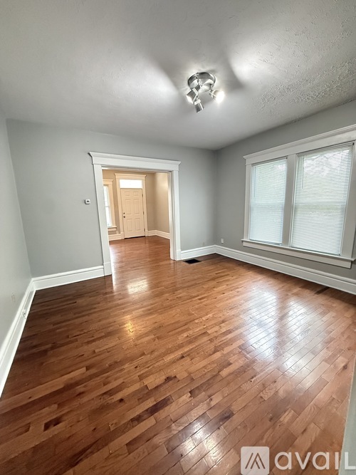 A room with wooden floors and a chandelier.