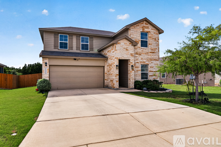 A house with a stone facade and a garage door.