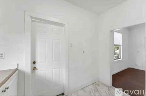 A white door is in a room with white walls.