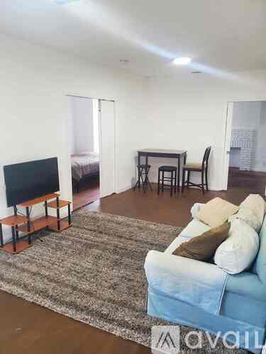 A living room with a blue couch and a television.