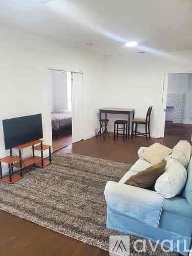 A living room with a blue couch and a television.