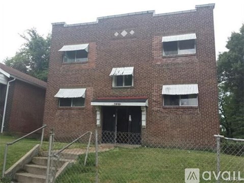 A brick building with a black door and windows.