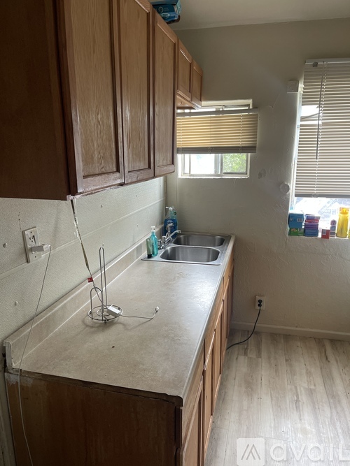 A kitchen with wooden cabinets and a white countertop.