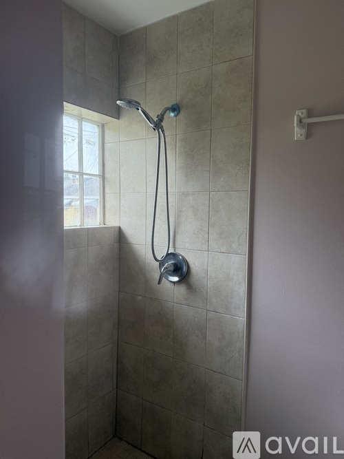 A shower head with a hose attached to it.