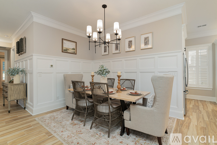 A dining room with a table set for six.
