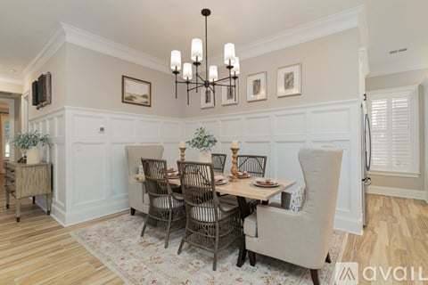 A dining room with a table set for six.