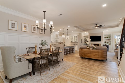 A spacious living room with a dining table set up with chairs and a couch.