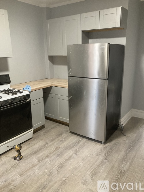 A kitchen with a stove, a refrigerator, and a counter.