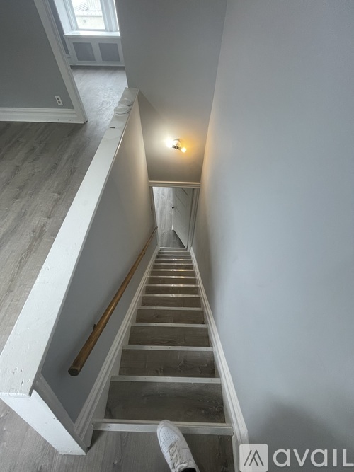 A staircase with a light on at the top.