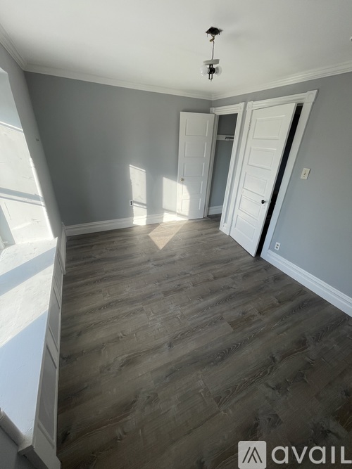 A room with grey walls and wooden flooring.