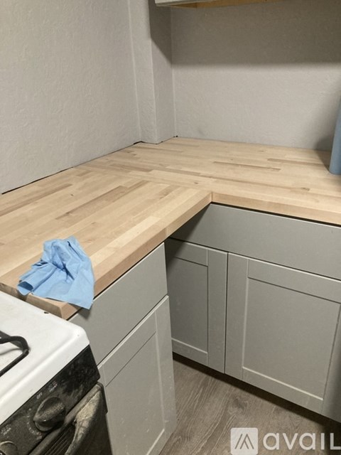 A kitchen with a white stove and wooden countertops.