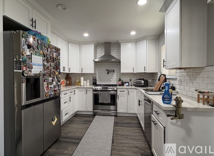 A kitchen with a refrigerator covered in magnets.