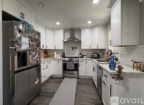 A kitchen with a refrigerator covered in magnets.