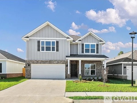 A two-story house with a garage is shown in the image.
