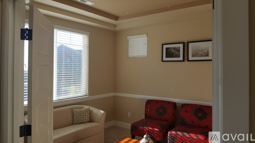 A living room with a couch and two chairs.