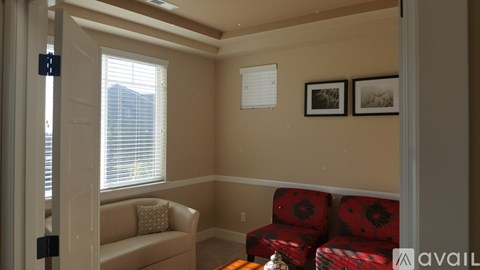 A living room with a couch and two chairs.