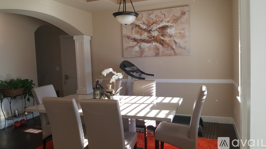 A dining room with a table and chairs.