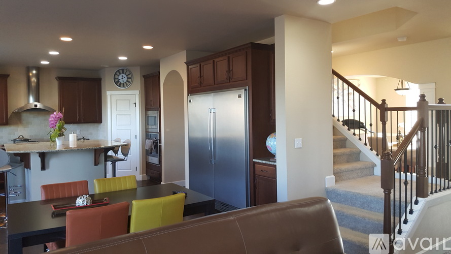 A modern kitchen with a dining table and chairs.