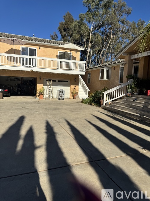 A house with a garage and a balcony is shown in the image.