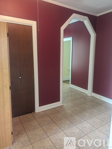 A room with red walls and a wooden door.