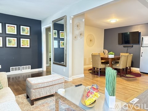 A living room with a grey sofa and a glass coffee table.