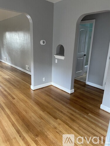A room with wooden floors and white walls.