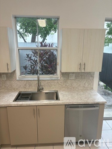 A kitchen with a sink and a window.