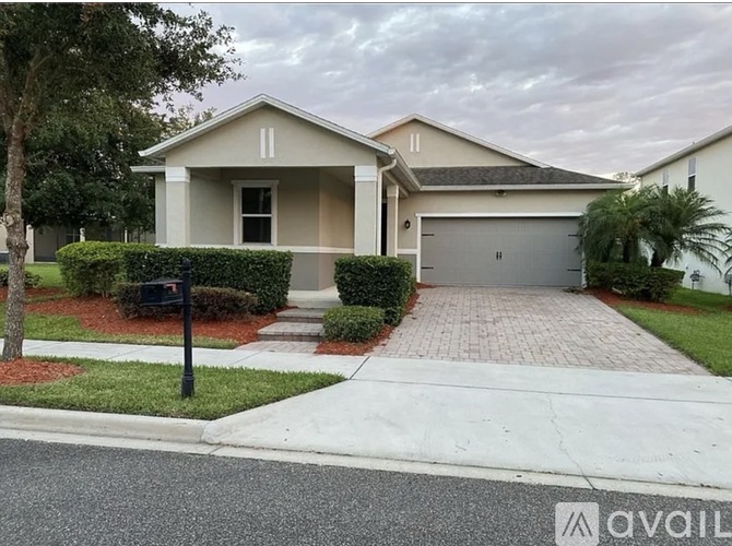 A house with a driveway and a garage is for sale.