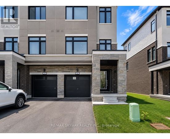 A modern two-story building with a garage is for sale.