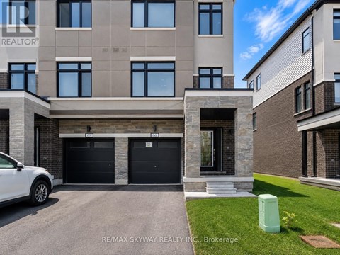 A modern two-story building with a garage is for sale.