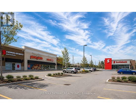 A parking lot with a sign that says RE/MAX SKYWAY REALTY INC. Brokerage.