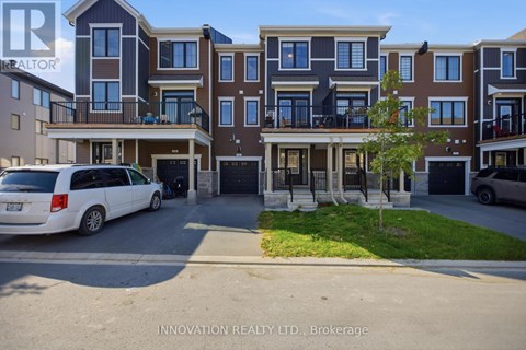 A white van is parked in front of a building with a sign that reads "INNOVATION REALTY LTD., Brokerage.".