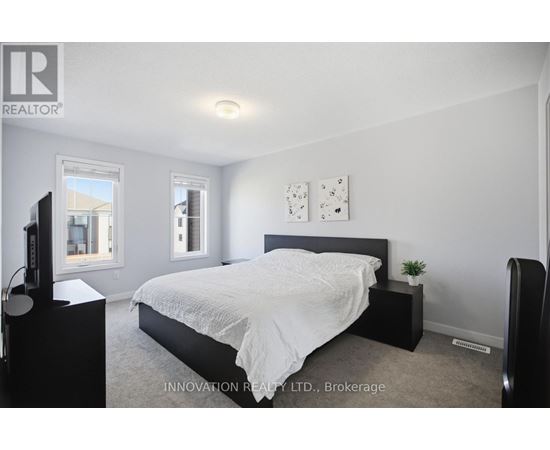 A bedroom with a large bed and a television.