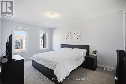 A bedroom with a large bed and a television.