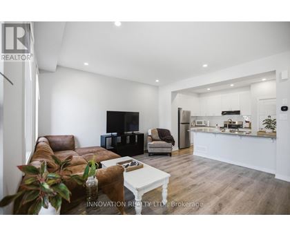 A modern living room with a brown leather couch and a white coffee table.