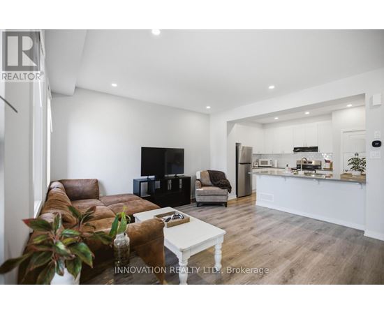 A modern living room with a brown leather couch and a white coffee table.