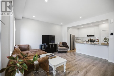 A modern living room with a brown leather couch and a white coffee table.