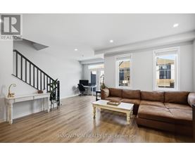 A living room with a brown leather couch and a white coffee table.