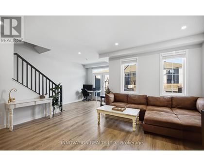 A living room with a brown leather couch and a white coffee table.