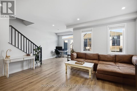 A living room with a brown leather couch and a white coffee table.