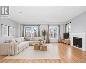 A living room with a white couch, a coffee table, and a fireplace.