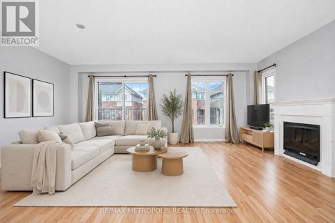 A living room with a white couch, a coffee table, and a fireplace.