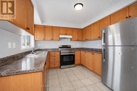 A kitchen with wooden cabinets and a granite countertop.