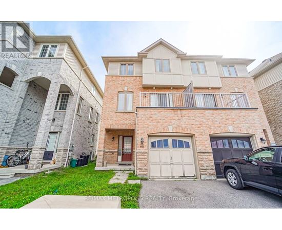 A two-story residential building with a garage and a balcony.