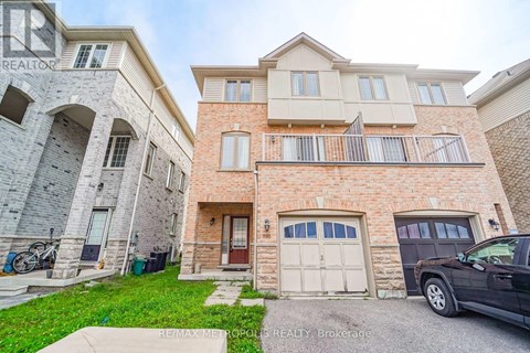 A two-story residential building with a garage and a balcony.
