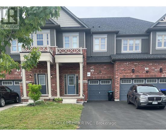 A two-story house with a garage and a car parked in front.