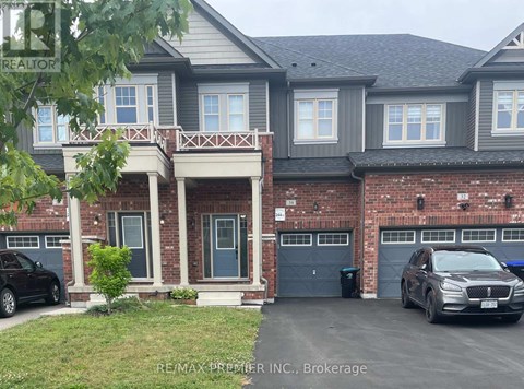 A two-story house with a garage and a car parked in front.
