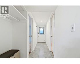 A hallway with a door on the right and a window on the door.