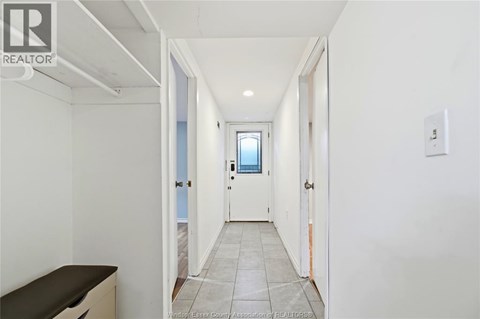 A hallway with a door on the right and a window on the door.