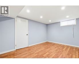 A room with a white door and a window with blinds.